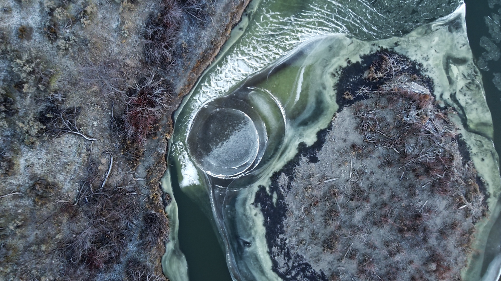 Aerial view of ice disc formation in partially frozen river during winter