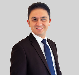 Kaveh Roshanbinfar wearing a balck suit with a dark blue tigh. This photograph is a formal setup.