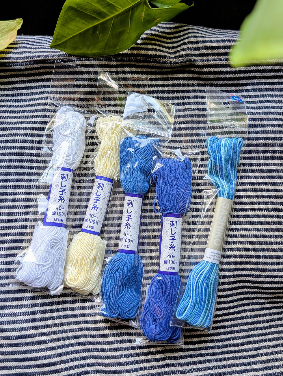 Japanese sashiko threads, white, cream, and indigo colored bundles