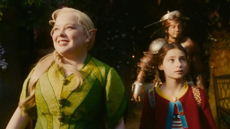 Elf woman in green coat, smiling, with a girl in a colorful sweater and a man in armor in a lush forest setting, all looking hopeful.