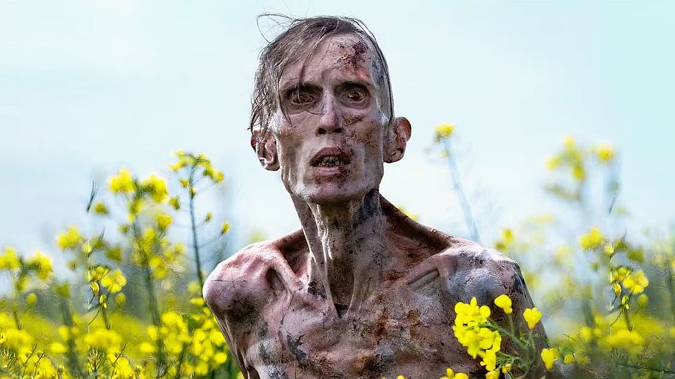 Gaunt person with dirt-streaked skin stands in a field of yellow flowers, under a clear blue sky, looking distressed and worn.