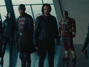 Six people in tactical gear stand in a modern building with large windows. They appear serious, ready for action. The mood is tense.