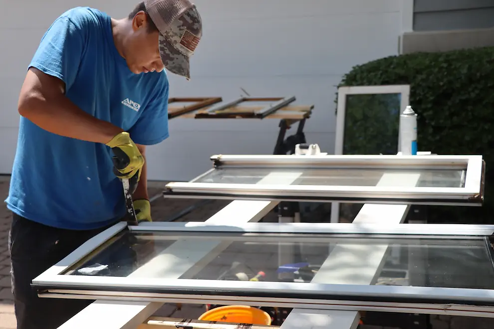 a man repairing double glazing for emergency glazier London