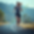 Woman in athletic wear running on a road with mountains in the background, digital graphs overlay, creating a dynamic and focused mood.