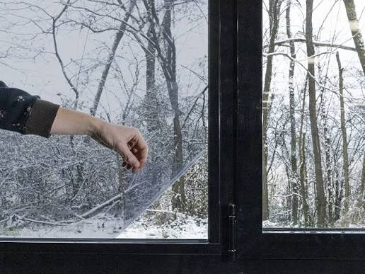 insulation window film installation by a man in a snowy location