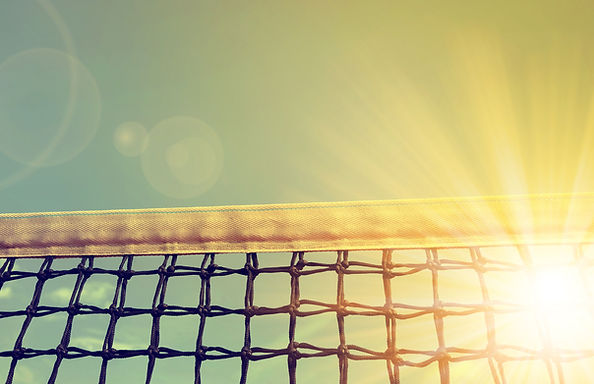 Tennis net with sunset sky in the background.jpg