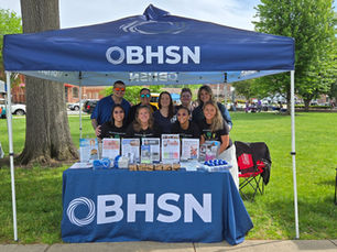 Group image outdoors with a table with resources