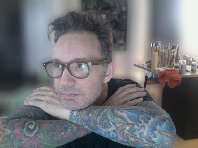 Edited image: Photoshop’s blur filter softens the background to focus on Jeff, his tattoos, and his painting tools.