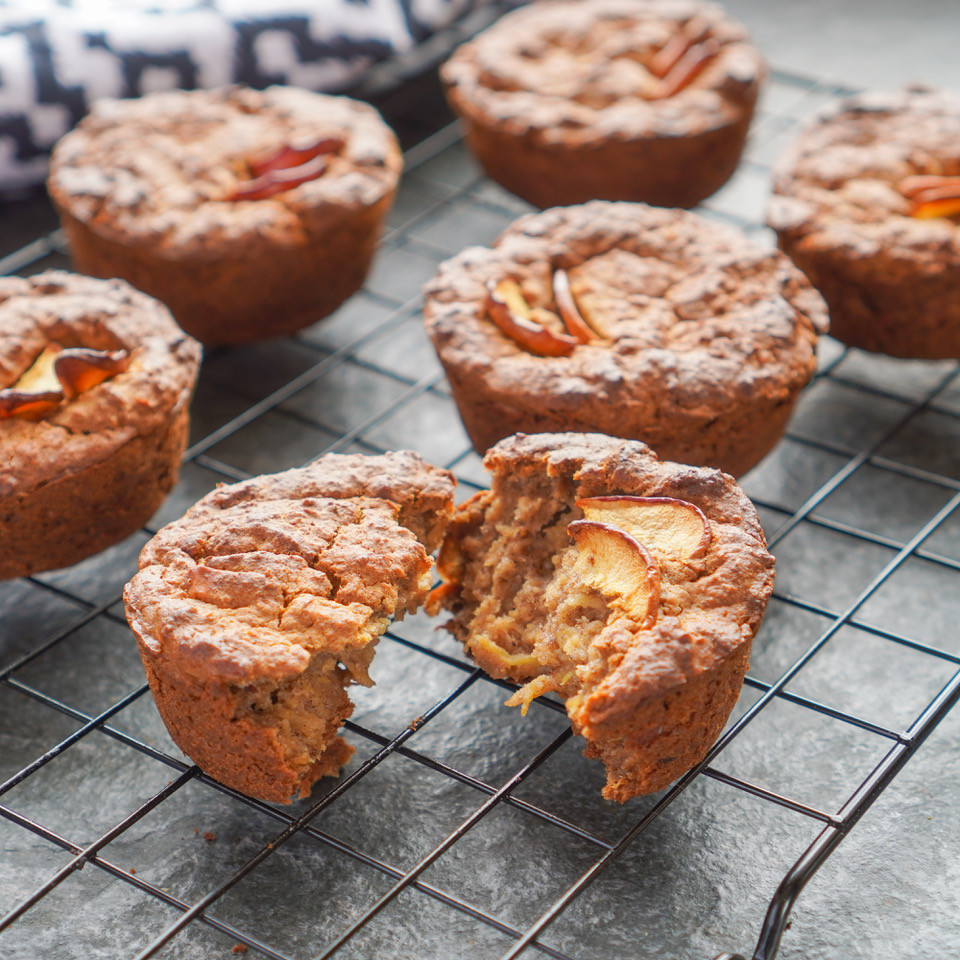 Warm apple and oat muffins cooling on a wire tray