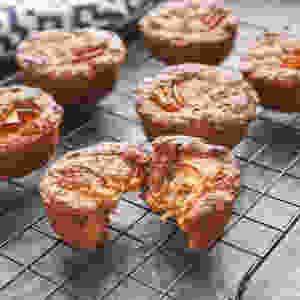 Warm apple and oat muffins cooling on a wire tray