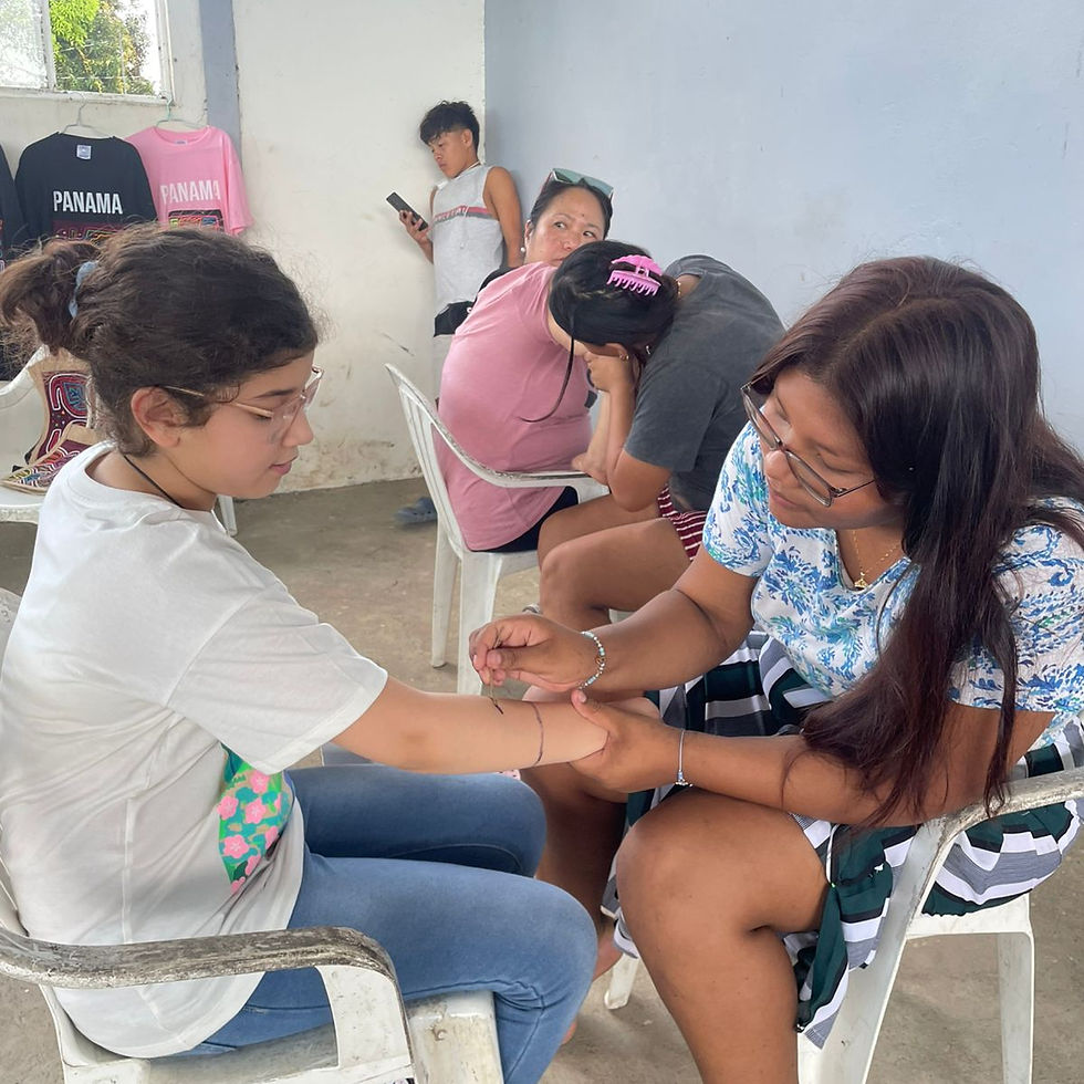 An artist meticulously applies jagua body art showcasing traditional techniques.