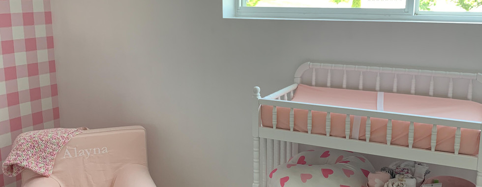 Little girl nursery changing table and chair with bow tie curtains.