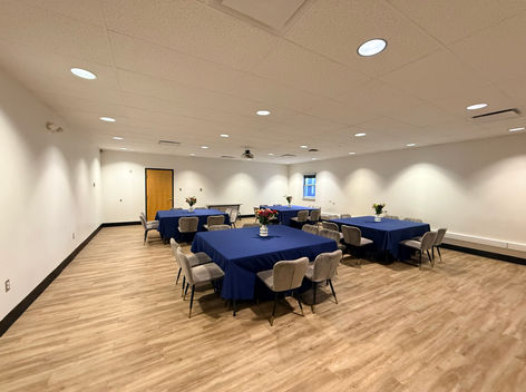 Goldman Board Room with tables and blue chair linens.