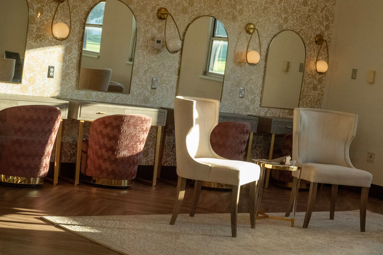 Elegant Gardner Bridal Suite with vanity stations and lounge.