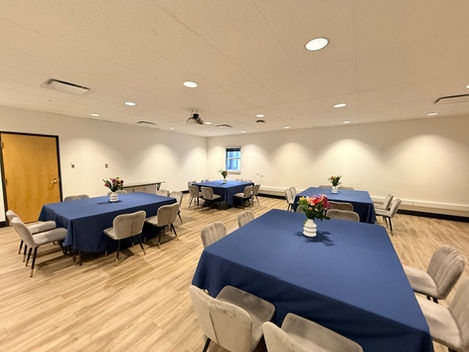 Goldman Board Room with tables and blue chair linens.