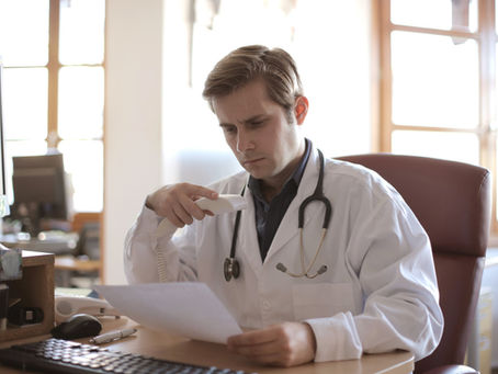 Physician analyzing income and tax charts