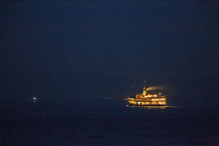 a large ship is floating on the water at night