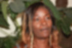 Close-up of a woman with long brown hair and earrings