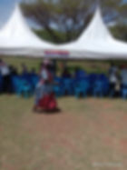 Woman passing a tent during NGO field work in Kenya