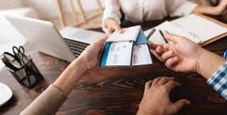 Travel advisor helping clients review vacation plans and travel documents