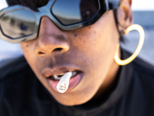A woman with a hemp joint in her mouth