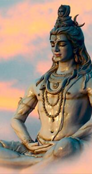 Statue of Lord Shiva meditatingagainst clouds