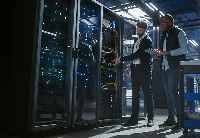 Tekmatik technicians performing maintenance on a commercial network server rack and infrastructure