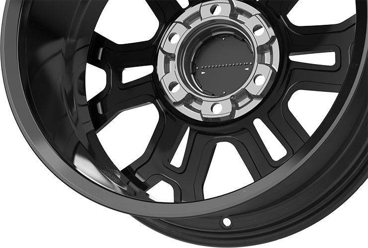 The Warrior wheel cap stands out with its striking gloss black finish and impeccable craftsmanship. The cap’s surface features a finely applied, high-quality paint, showcasing a superior coating process. Surrounding it is a beautifully plated metallic ring, adding an elegant chrome-like touch. Beneath the cap, a distinctive grid pattern reflects the intricate design and attention to detail. This blend of refined aesthetics and sophisticated engineering enhances the wheel’s overall look, offering both style and durability.