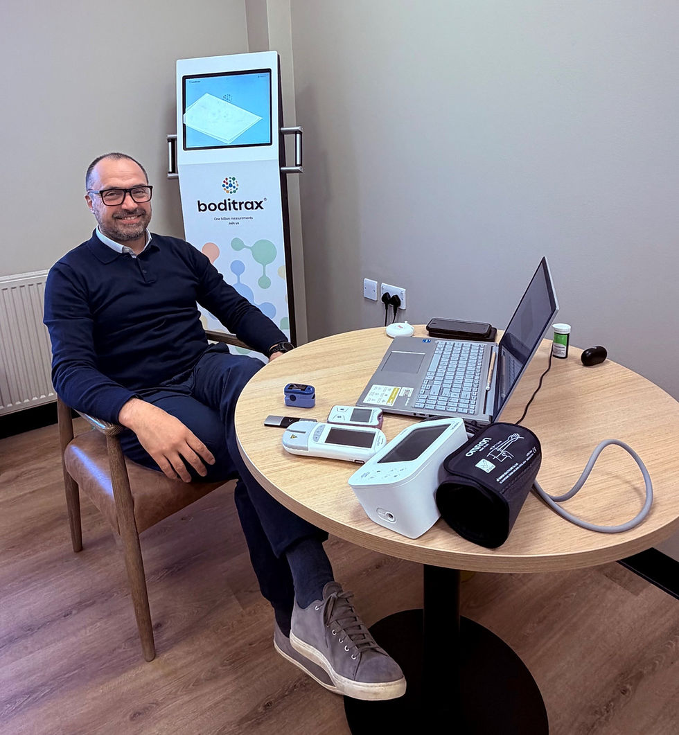 Man sitting next to health equipment on a desk