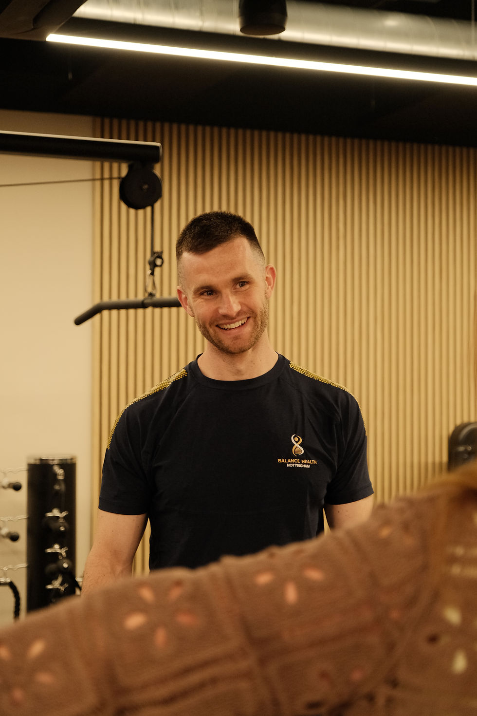 Smiling man motivating a gym user