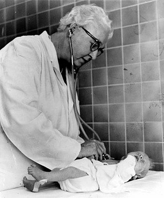 Dr. Apgar examining a newborn