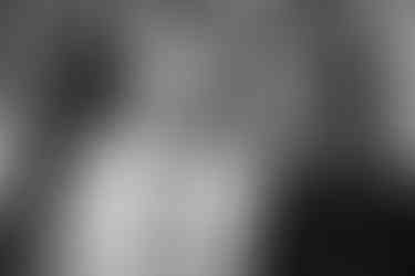 a man in white dress shirt and black  tie singing