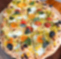 Vegetarian pizza with corn, cherry tomatoes, and basil