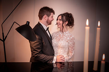 Natural, unposed bride and groom smiling at each other behind piano at Hope Street Hotel wedding by Gemma Cullen, Liverpool wedding photographer
