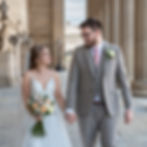 Bride and groom walking hand in hand at St George's Hall in Liverpool captured in a relaxed and timeless wedding photography style