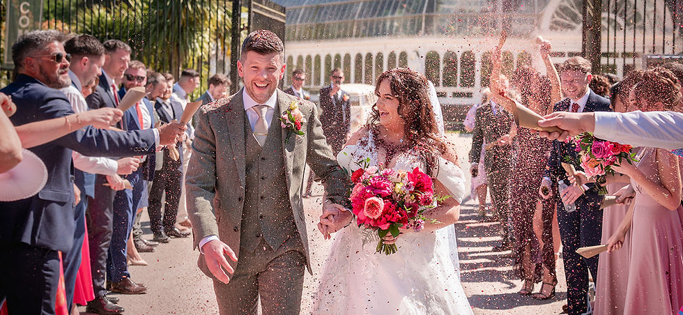 Bride and groom walking through confetti at the Sefton Park Parlm House, Liverpool