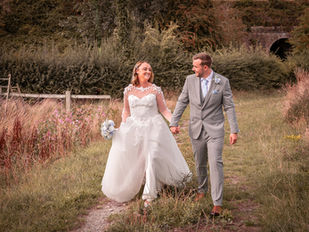 Bride and Groom walking hand in hand at the Barn at Yew Tree Farm in Liverpool