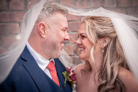 Bride and groom under veil at Hope Street Hotel, Liverpool