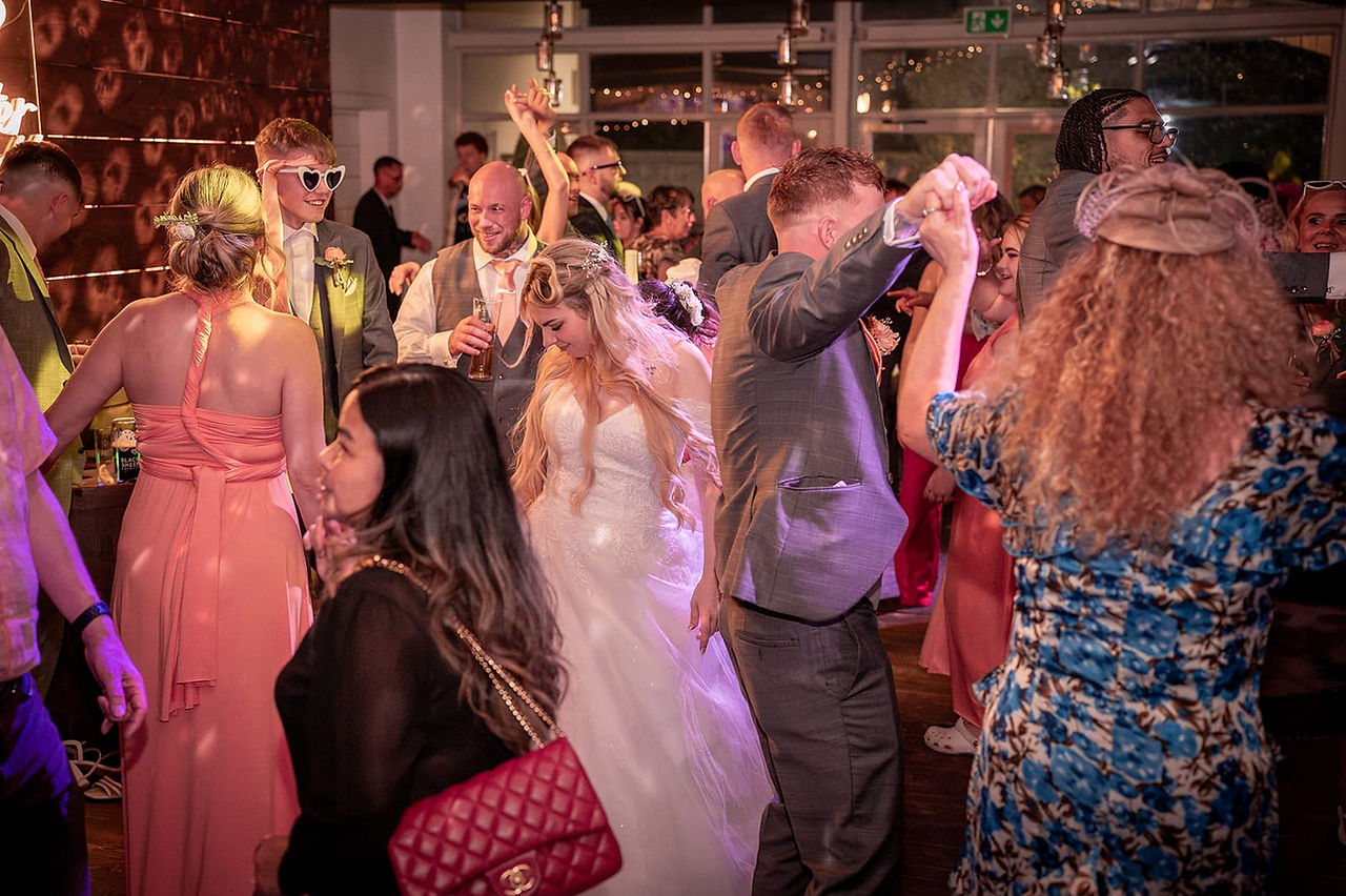 All wedding guests on the dance floor at Bashall Barn