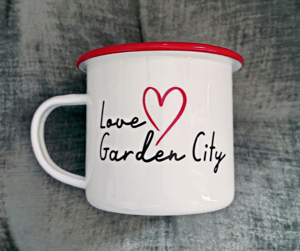 White enamel mug with Love Garden City and red heart.