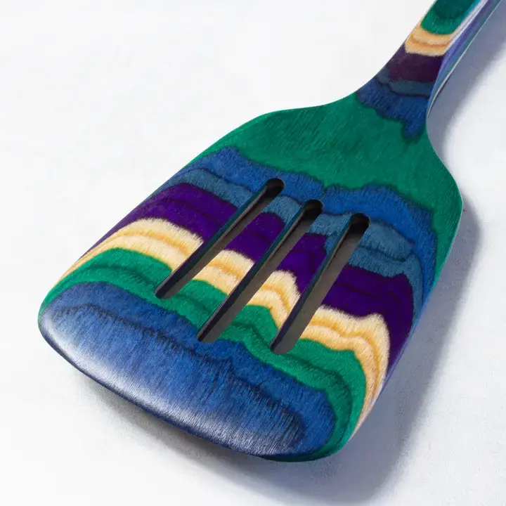 Colorful wooden slotted spatula, 12.5" Baltique® Mumbai, close up.