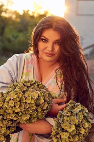 Mezzo-soprano Kseniia Nikolaieva portrait with hydrangeas