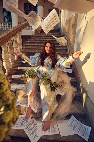 Mezzo-soprano Kseniia Nikolaieva, flying scores, on stairs, opera