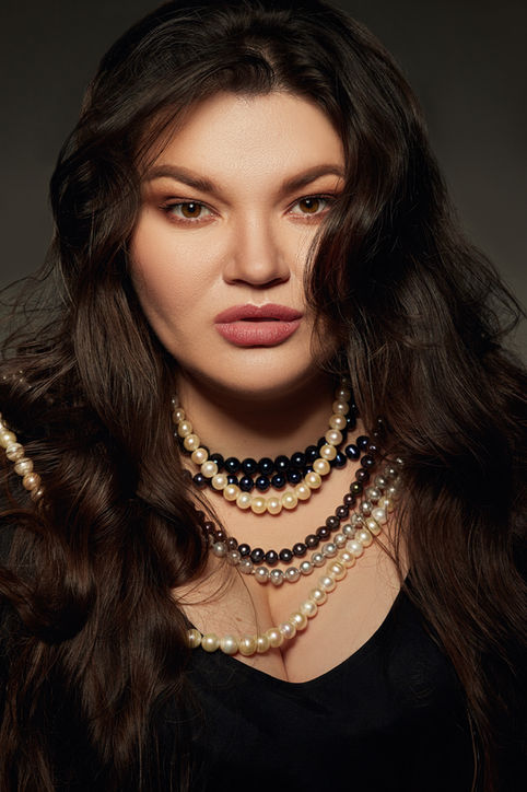 Opera singer Kseniia Nikolaieva close portrait with beads