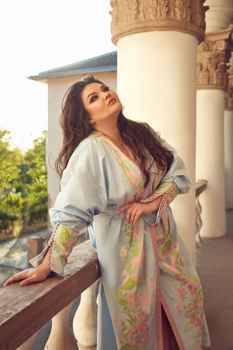 Opera singer Kseniia Nikolaieva in an ornate floral blue coat