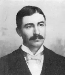 W.A. Waterman in a vintage suit with a bow tie and mustache posing against a neutral background.