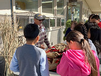 A male teacher talks about how to create duck forms out of tule reeds. The forms are seen on a table.