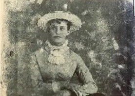 Black and white photo of Nancy Jane wearing a fancy dress and hat.