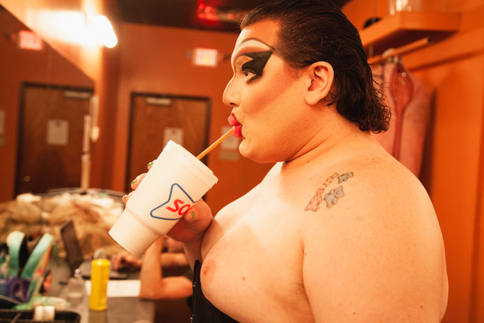 Portrait of a drag queen sipping from a large Sonic cup by Little Rock artist Katie Adkins. 