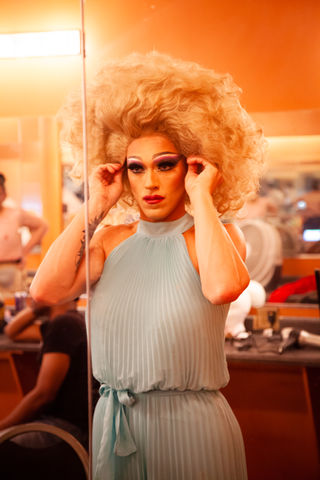 Photograph of drag queen adjusting blonde wig by artist Katie Adkins